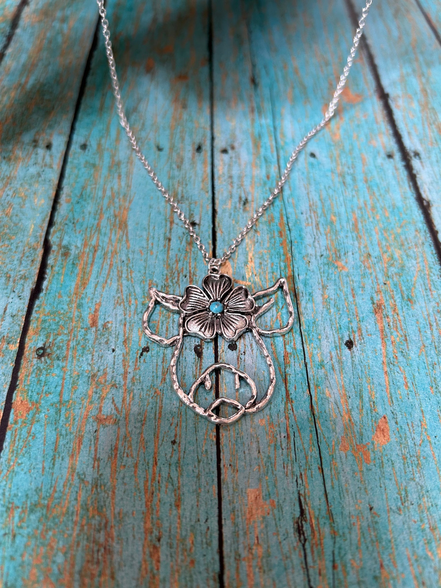 Silver Pig Necklace Featuring a Flower Design