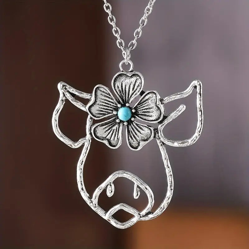 Silver Pig Necklace Featuring a Flower Design